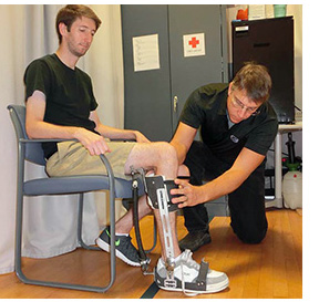 Dr. Ferris fitting an exoskeleton on a participant