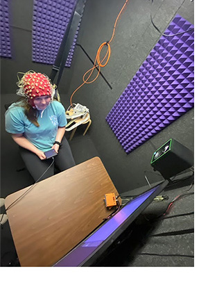 A subject participates in a listening experiment in the Auditory Learning & Cognition Lab