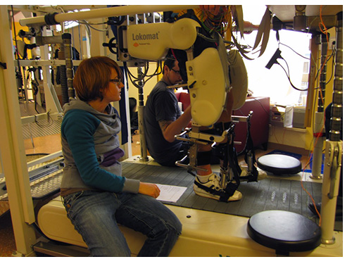 Dr. Wagner preparing a participant for an EEG recording in an exoskeleton gait orthosis