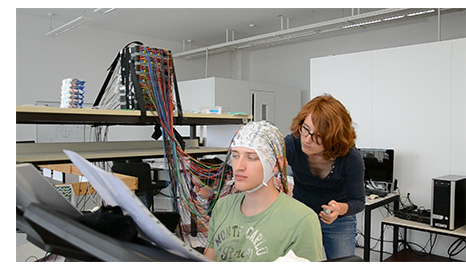 Dr. Wagner prepares a participant for an EEG gait recording